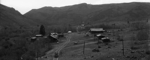 Panoramic black and white photograph of Jasper in the 1910s showing buildings along a dirt road